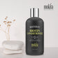 Biotin conditioner bottle with decorative stones and flowers on a light background