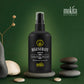 Black serum bottle labeled 'Regenerate Serum' by mokita on a green background with stones and a plant.